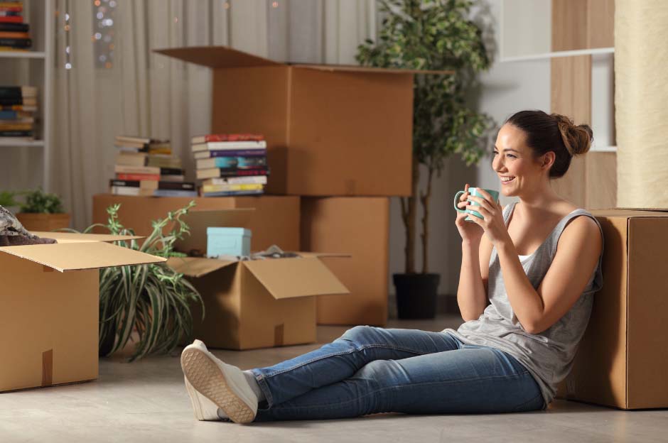 First time buyer enjoying a brew whislt moving into her new home. The image is used to symbolise first time buyer mortgages offered by Whitewood Mortgages.